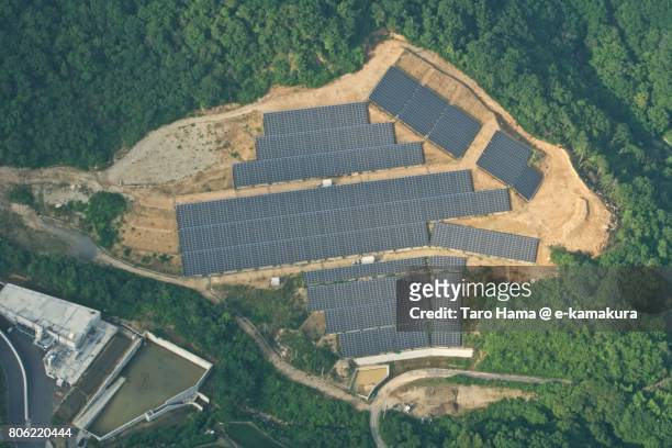solar panels on mountain daytime aerial view from airplane - stadt okayama stock-fotos und bilder