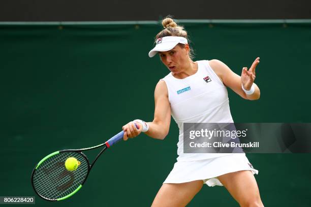 Marina Erakovic of New Zealand plays a forehand during the Ladies Singles first round match against Simona Halep of Romania on day one of the...