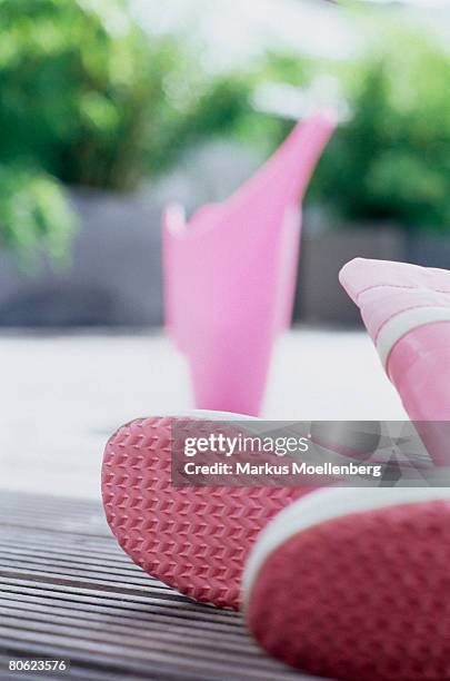 pink rubber boots and watering can on - waterproof deck stock pictures, royalty-free photos & images