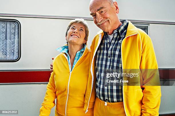 happy couple in matching sweatsuits - tracksuit stock pictures, royalty-free photos & images