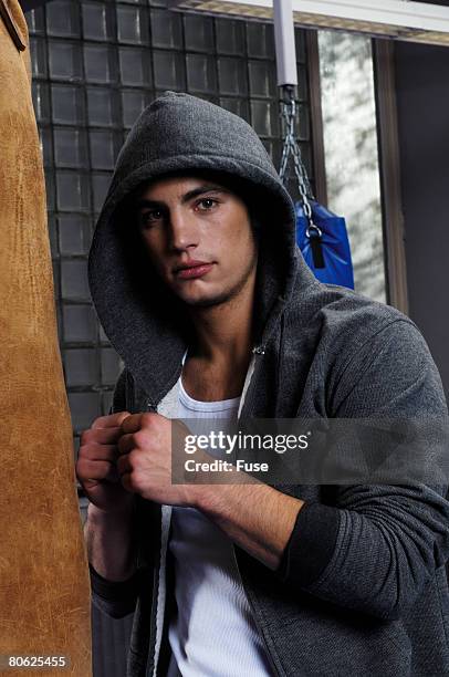 boxer training with punching bag - fighter portraits stock pictures, royalty-free photos & images