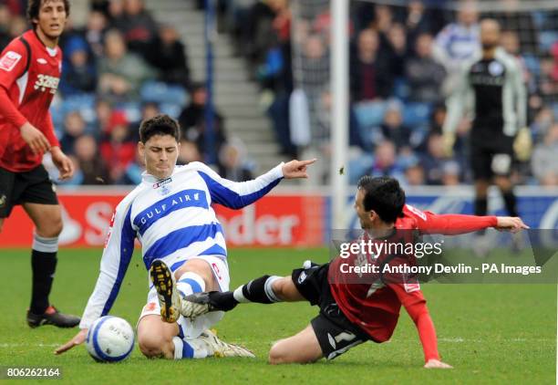 Swansea City's Leon Britton tackles Queens Park Rangers' Alejandro Faurlin during the Coca-Cola Championship match at Loftus Road, London.