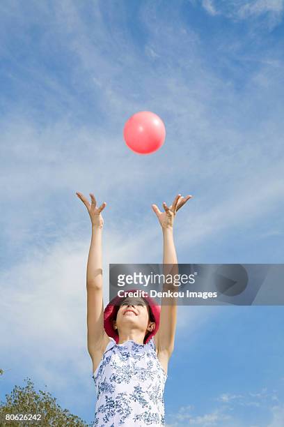 girl throwing pink ball in air - ring toss bildbanksfoton och bilder
