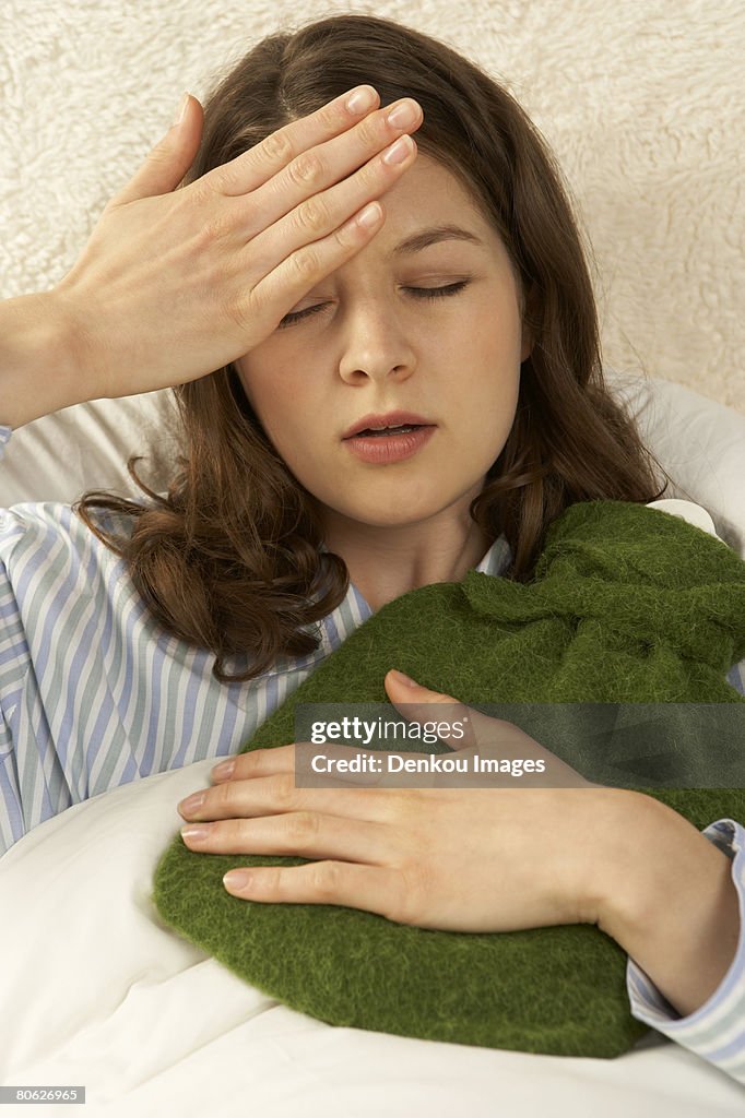 Mid adult woman suffering from fever