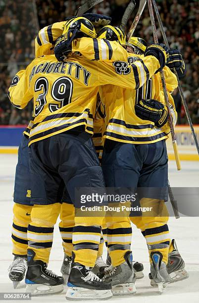 The Michigan Wolverines celebrate after scoring their first goal against the Notre Dame Fighting Irish during their semifinal game at the 2008 NCAA...