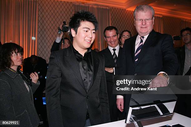 Pianist Lang Lang and Sir Howard Stringer, Chairman and CEO of Sony, look at Sony products at an event held to announce Sony's three year sponsorship...