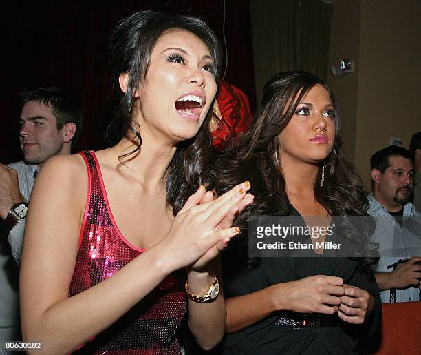 Miss Universe 2007 Riyo Mori and Miss Teen USA 2007 Hilary Cruz react as they watch a fashion show at the Fashion Rocks the Universe! event at the...