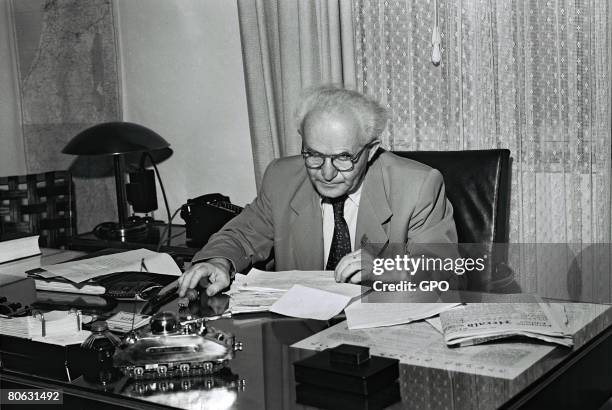 David Ben Gurion, the first Prime Minister of the Jewish State, in his office September 1, 1949 in Tel Aviv, Israel. The model of a tank on his desk...