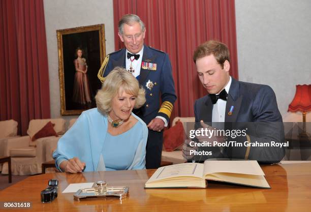 Prince Charles, Prince of Wales in his role as Air Chief Marshal, Camilla, Duchess of Cornwall and Prince William sign the visitor's book after...