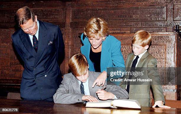 Prince William signs in on his first day at Eton College watched by his parents, the Prince and Princess of Wales and brother, Prince Harry on...