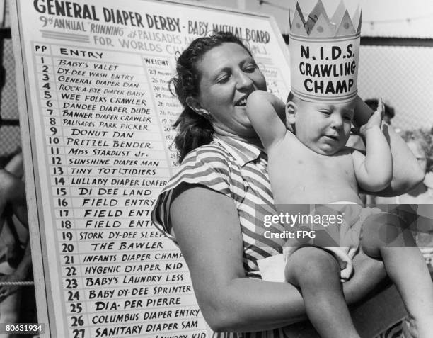 Eleven month old Peter Ruttenberg with his mother after winning the Diaper Derby at the Palisades Amusement Park, New Jersey, 1947.
