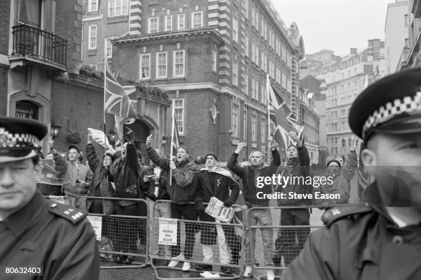 Supporters of the British far-right National Front party stage a counter-demonstration during a protest march though London on the 27th anniversary...