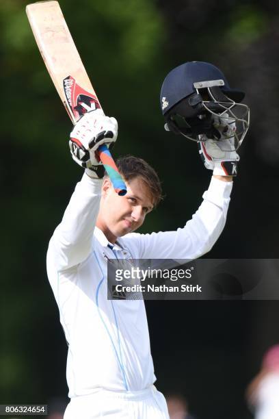 Matt Critchley of Derbyshire raises his bat after scoring a hundred during the Specsavers County Championship Division Two match between Derbyshire...