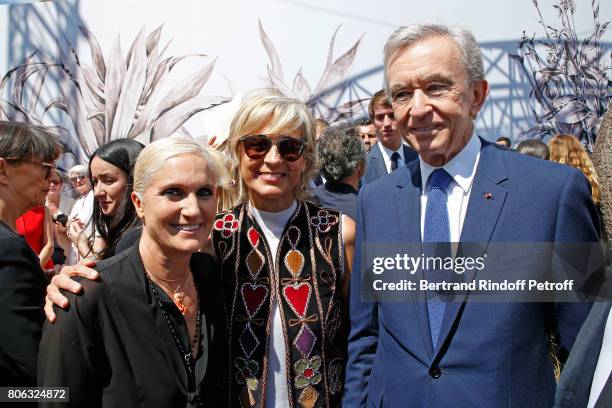 Stylist Maria Grazia Chiuri, Owner of LVMH Luxury Group Bernard Arnault and his wife Helene Arnault pose backstage after the Christian Dior Haute...