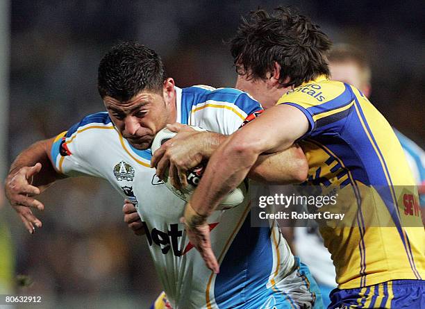 Mark Minichiello of the Titans is tackled by the Eels during the round five NRL match between the Parramatta Eels and the Gold Coast Titans at...