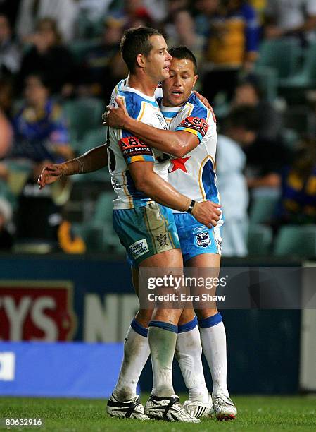Scott Prince of the Titans is congratulated by Ashley Harrison after scoring a try during the round five NRL match between the Parramatta Eels and...