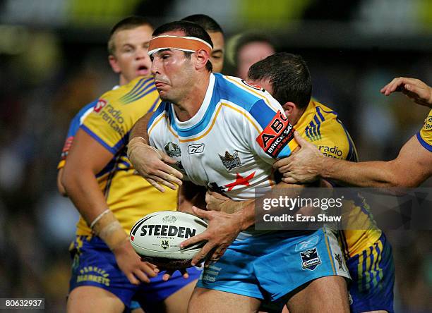 Anthony Laffranchi of the Titans is tackled by the Eels during the round five NRL match between the Parramatta Eels and the Gold Coast Titans at...