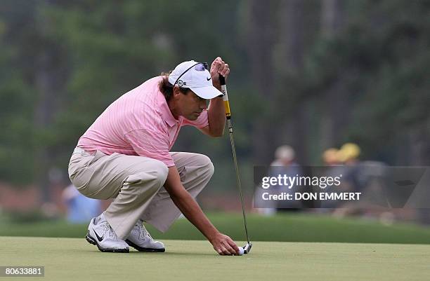 Canadian golfer Stephen Ames sets up his putt on te third green during the second round of the US Masters at the Augusta National Golf Club on April...