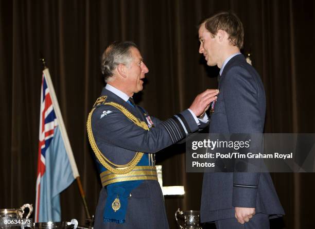 Prince Charles, Prince of Wales in his role as Air Chief Marshal presents Prince William with his RAF wings in a graduation ceremony at the end of...