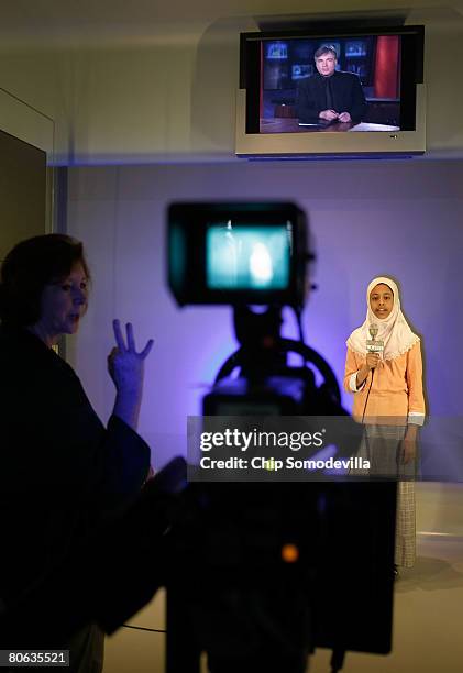 Misky Sharif of Lansdowne, Virginia, reads a news script for the television camera in the "Be A TV Reporter" section of The Newseum during its grand...