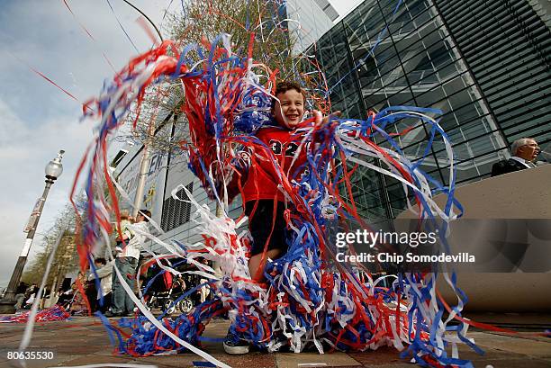 Nick Bennett of New Orleans, Louisana, wraps himself in confetti streamers during the grand opening of The Newseum April 11, 2008 in Washington, DC....