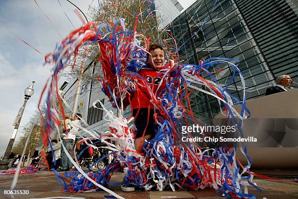 Nick Bennett of New Orleans, Louisana, wraps himself in confetti streamers during the grand opening of The Newseum April 11, 2008 in Washington, DC....