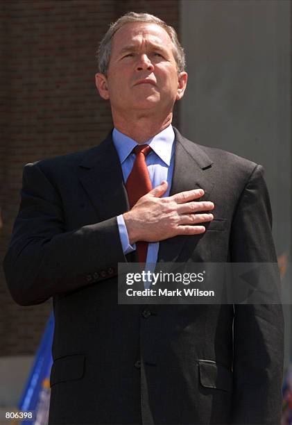 President George W. Bush listens to the National Anthem before making remarks on missile defense at the National Defense University at Fort McNair,...