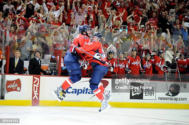 Mike Green celebrates with Alex Ovechkin of the Washington Capitals after scoring against the Philadelphia Flyers during the third period of game one...