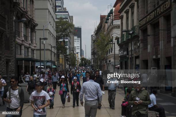 Pedestrians pass in front of stores on Francisco I. Madero Avenue in Mexico City, Mexico, on Monday, June 26, 2017. The National Institute of...