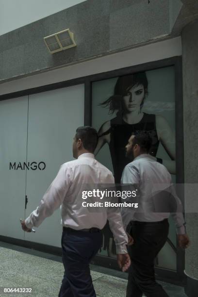 Pedestrians pass in front of a Mango Mng SL store on Francisco I. Madero Avenue in Mexico City, Mexico, on Monday, June 26, 2017. The National...
