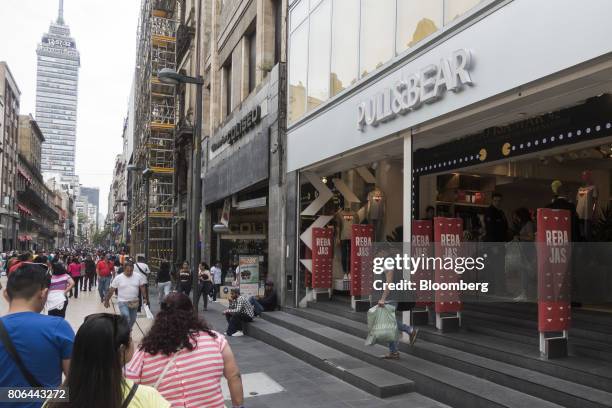 Shopper exits a Pull & Bear clothing store on Francisco I. Madero Avenue in Mexico City, Mexico, on Monday, June 26, 2017. The National Institute of...