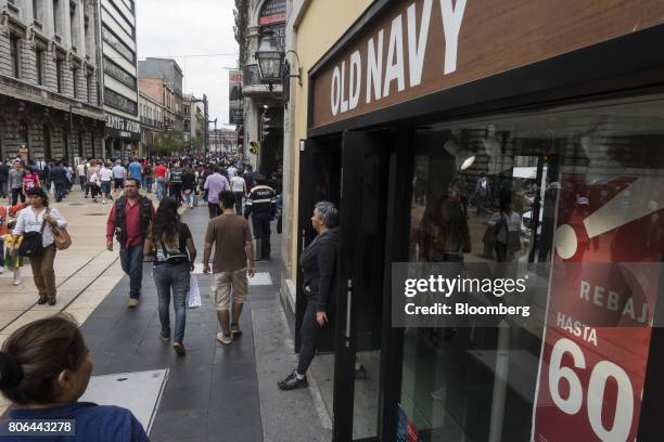 Shopper exits a Old Navy Inc. Store on Francisco I. Madero Avenue in Mexico City, Mexico, on Monday, June 26, 2017. The National Institute of...