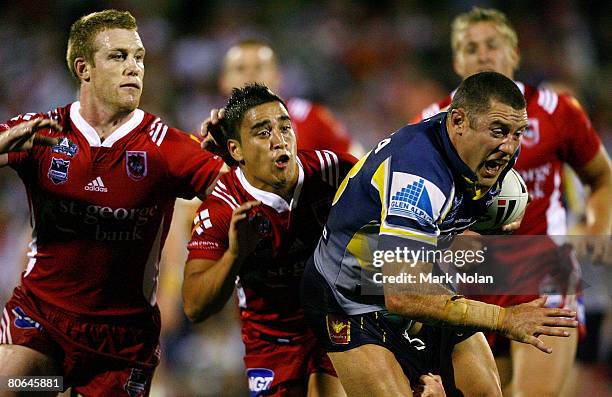 Ben Creagh and Rangi Chase of the Dragons tackle Luke O'Donnell of the Cowboys during the round five NRL match between the St George Illawarra...