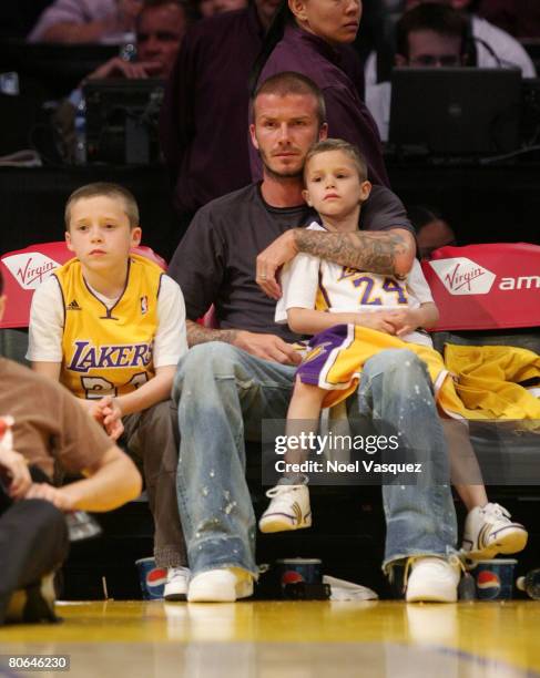 David Beckham and his two sons: Brooklyn and Romeo attend the Los Angeles Lakers against the New Orleans Hornets at the Staples Center on April 11,...