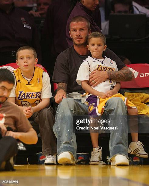 David Beckham and his two sons: Brooklyn and Romeo attend the Los Angeles Lakers against the New Orleans Hornets at the Staples Center on April 11,...