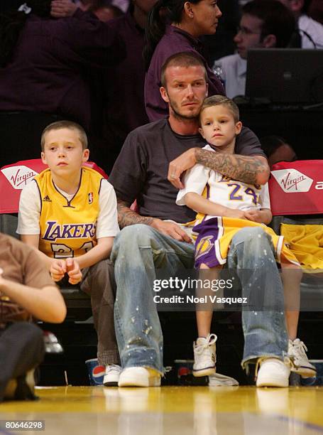 David Beckham and his two sons: Brooklyn and Romeo attend the Los Angeles Lakers against the New Orleans Hornets at the Staples Center on April 11,...