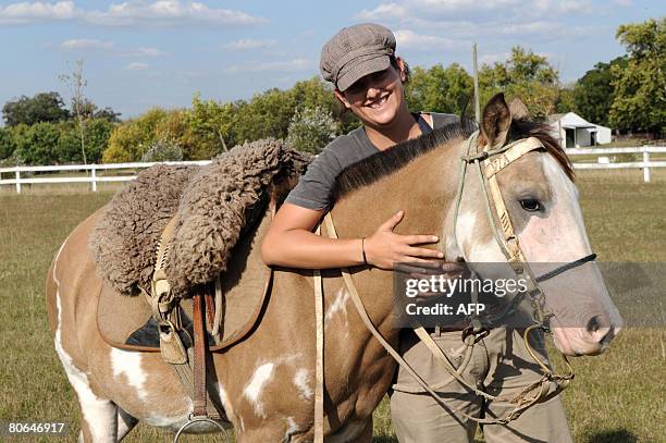Alma Hojman, a 23-year-old Israeli, hugs a two-year filly during a wild horse "rational" taming class at the Agricultural and Livestock Society in...