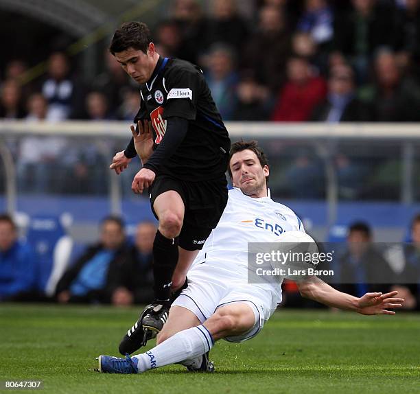 Fin Bartels of Rostock in action with Mario Eggimann of Karlsruhe during the Bundesliga match between Karlsruher SC and Hansa Rostock at the Wildpark...