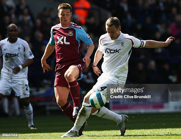 Scott Parker of West Ham United challenges Kevin Nolan of Bolton Wanderers during the Barclays Premier League match between Bolton Wanderers and West...