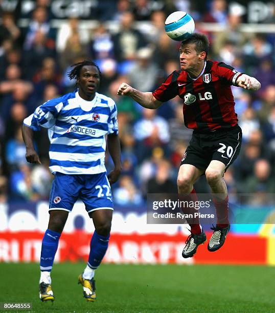 Brian McBride of Fulham wins the ball over Andre Bikey of Reading during the Barclays Premier League match between Reading and Fulham at the Madejski...