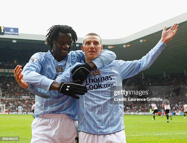 Elano of Manchester City is congratulated by Mwaruwari Benjani on scoring from the penalty spot during the Barclays Premier League match between...