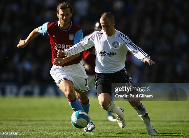 Patrick Berger of Aston Villa battles for the ball with Kenny Miller of Derby County during the Barclays Premier League match between Derby County...