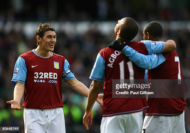 Gareth Barry of Aston Villa celebrates with Gabriel Agbonlahor and Ashley Young after scoring the fourth goal for Aston Villa during the Barclays...