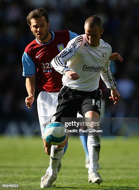 Patrick Berger of Aston Villa battles for the ball with Kenny Miller of Derby County during the Barclays Premier League match between Derby County...