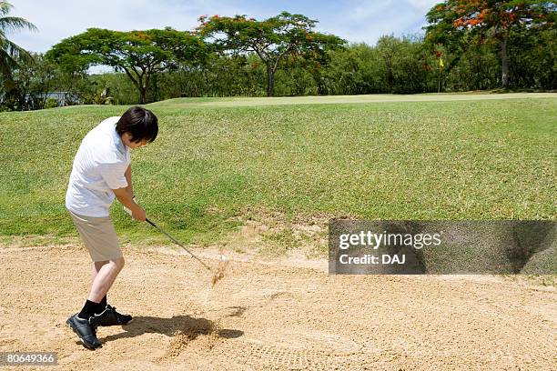 man blasting a ball out of a bunker - sand blasting stock pictures, royalty-free photos & images