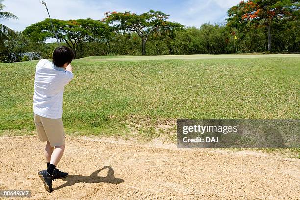 man blasting  ball out of  bunker - sand blasting stock pictures, royalty-free photos & images