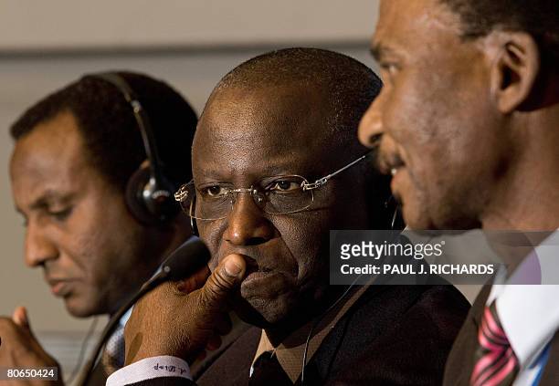 Senegal's Minister of Economy and Finance Abdoulaye Diop listens to a reporter's question as Nigerian Finance Minister Ali M. Lamine Zeine and...
