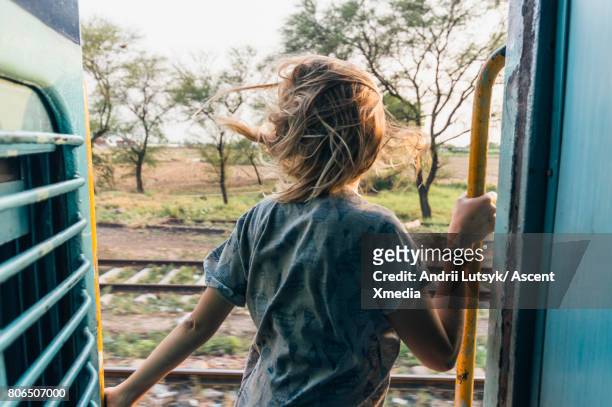 Young woman rides train through rural area