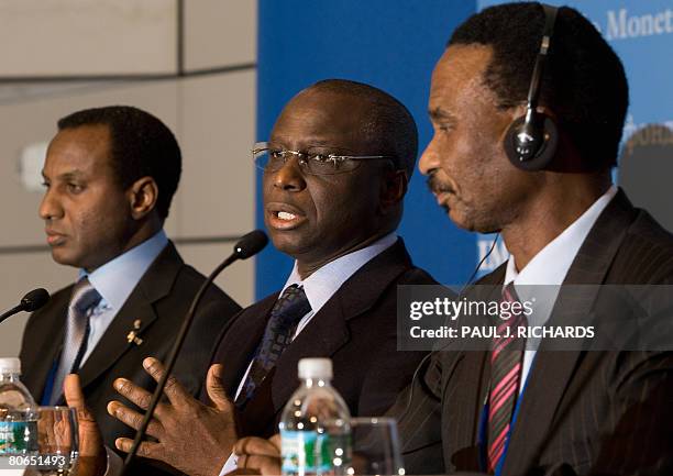 Senegal's Minister of Economy and Finance Abdoulaye Diop listens to a reporter's question as Nigerian Finance Minister Ali M. Lamine Zeine and...