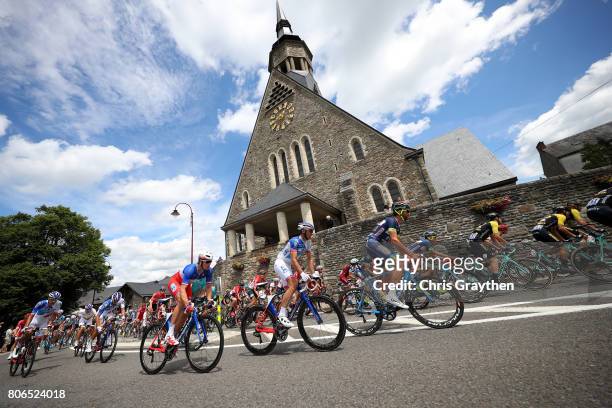 The peloton rides past a church during stage three of the 2017 Le Tour de France, a 212.5km stage from Verviers to Longwy on July 3, 2017 in...